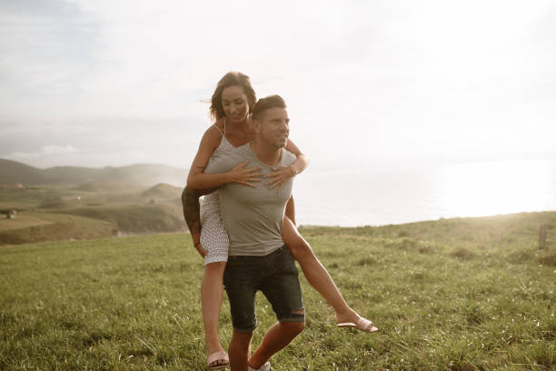 istock Young couple walking piggyback 1269682896