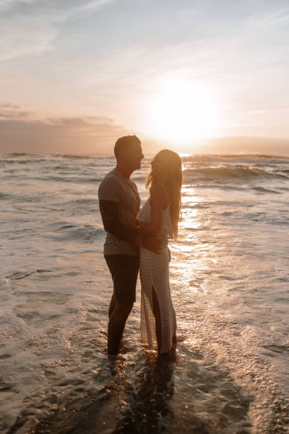 istock Young couple at the beach at sunset 1269684814
