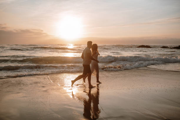 istock Young couple running and having fun at the beach 1269684826