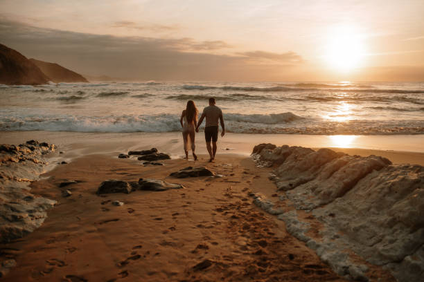 istock Rear view of a young couple at a beach 1269684827