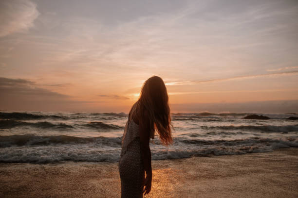 istock Rear view of a young woman at a beach 1269684957