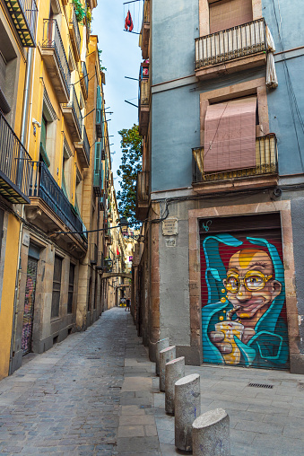 Barcelona, Spain - 01 August 2019. Graffiti on a narrow street in the old town.