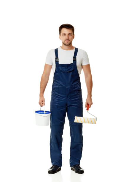 istock repairman holding paint roller and can with paint. 1269687046