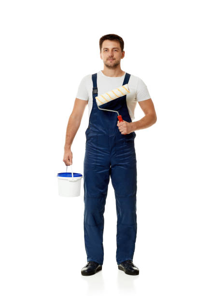 istock repairman holding paint roller and can with paint. 1269687055