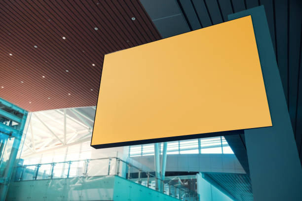 istock Blank Board for Mockup. Empty Yellow Horizontal Poster. Indoor Scene in Modern Public Building. Clipping Path Included 1269687147