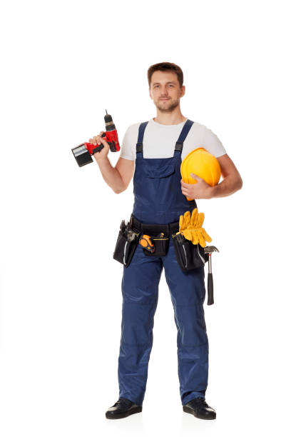 young caucasian repairman worker with yellow hard hat holding cordless screwdriver - holding screwdriver imagens e fotografias de stock