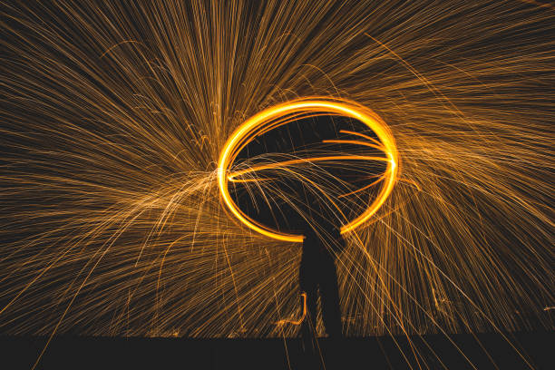 istock Male spins with steel wool and makes a circle over his head 1269688965