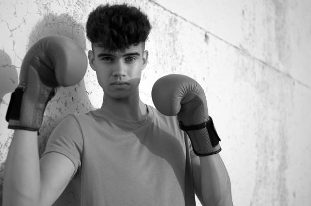 istock Young man with boxing gloves in defense position, with copy space. 1269689877