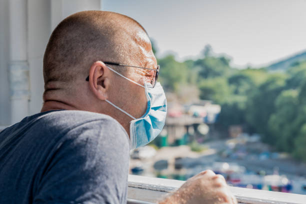 istock Man with the Protective Mask Looking from the Window while Traveling with the Ferry Boat 1269690043