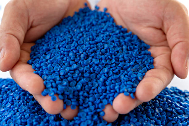 istock Blue plastic grain, plastic polymer granules,hand hold Polymer pellets, Raw materials for making water pipes, Plastics from petrochemicals and compound extrusion, resin from plant polyethylene. 1269691659