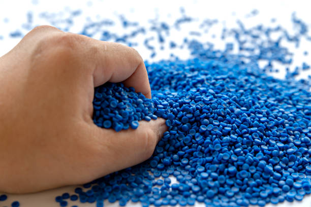 istock Blue plastic grain, plastic polymer granules,hand hold Polymer pellets, Raw materials for making water pipes, Plastics from petrochemicals and compound extrusion, resin from plant polyethylene. 1269691684