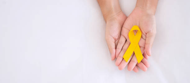 Suicide prevention and Childhood Cancer Awareness, Yellow Ribbon for supporting people living and illness. children Healthcare and World cancer day concept Suicide prevention and Childhood Cancer Awareness, Yellow Ribbon for supporting people living and illness. children Healthcare and World cancer day concept september stock pictures, royalty-free photos & images