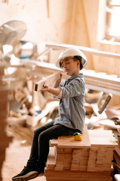 istock Boy builds a toy of wood 1269691849