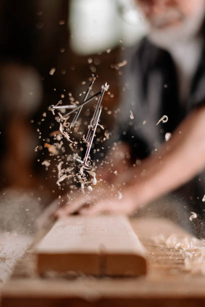 Close up of carpenter woodworking stock photo Close up of carpenter woodworking stock photo. Shallow DOF. Developed from RAW; retouched with special care and attention; Small amount of grain added for best final impression. 16 bit Adobe RGB colour profile. hit the nail on the head stock pictures, royalty-free photos & images