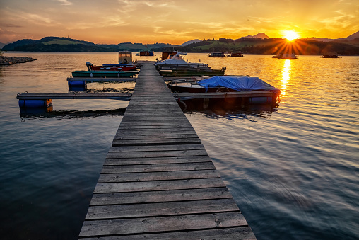 Colorful sunset  on lake Liptovska Mara, Slovakia. Boats in port