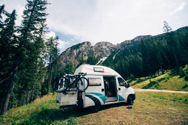 Cute camper van RV in wild camping spot in nature