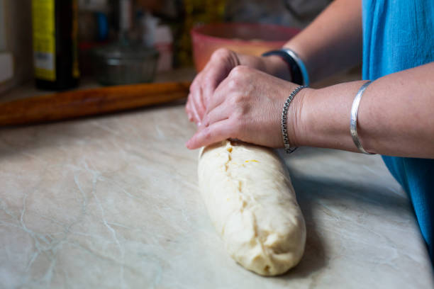 istock Poppy seed stuffing for pie. Forming yeast dough for pie with women hands 1269694278