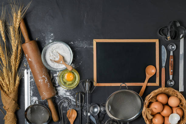istock Blank blackboard and fresh eggs, cake flour with kitchen utensils for pastries 1269694874