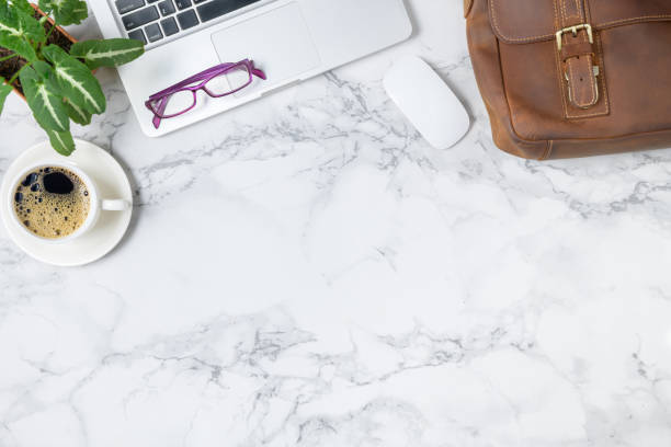 istock Vintage Leather bag and  laptop with black coffee isolated on marble table 1269694970