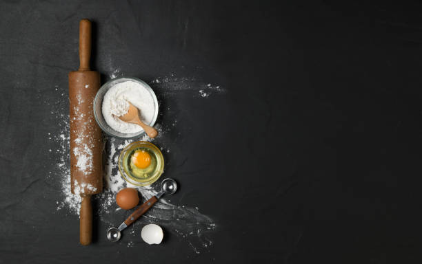 istock rolling pin with cake flour and fresh eggs on black table 1269695006