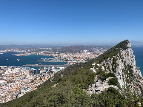 View looking north of the rock of Gibraltar, August 2020, with runway, town and Spain in picture