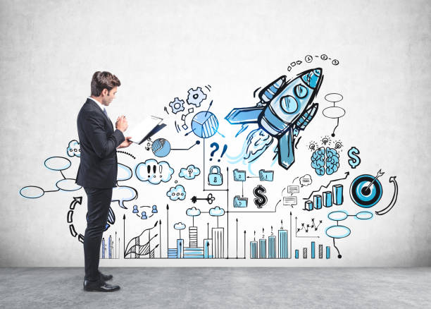 istock Manager with clipboard looking at startup sketch 1269695467