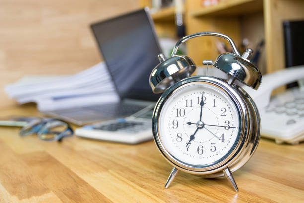 istock clock on work desk  in the work office Time of working concepts office life on morning, selective focus the clock 1269695533
