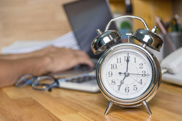 istock clock on work desk  in the work office Time of working concepts office life on morning, selective focus the clock 1269695552