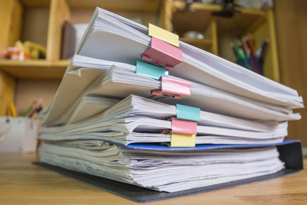 istock file folder and Stack of business report paper file on the table in a work office, concept document in work office 1269696073