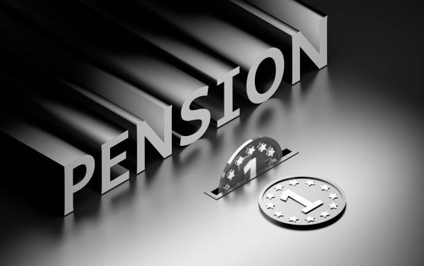 istock Word Pension with large silver coins on black background 1269696217