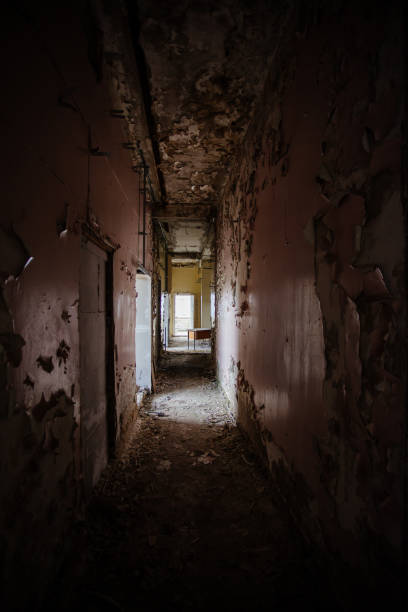 istock Dark creepy corridor of abandoned building 1269696661