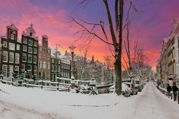 Photo of City scenic from snowy Amsterdam in the Netherlands at sunset