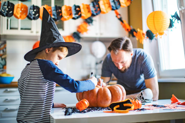 istock Father and son getting ready for Halloween party at home 1269697641