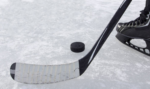 istock hockey stick puck and skate 1269698258