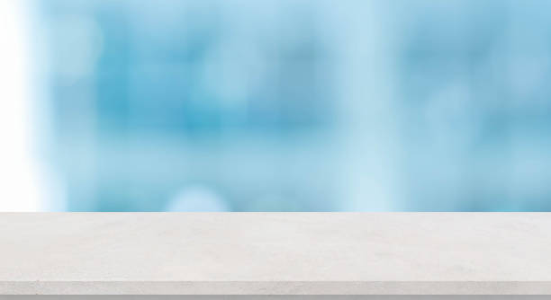 istock blurred inside of interior modern bathroom in the morning background with white concrete tabletop for show, promote ads and design product on display concept 1269699122