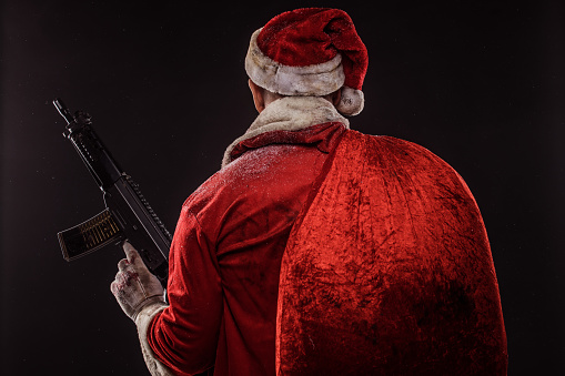 Portrait of weapon wielding redhead bad ass Santa Claus