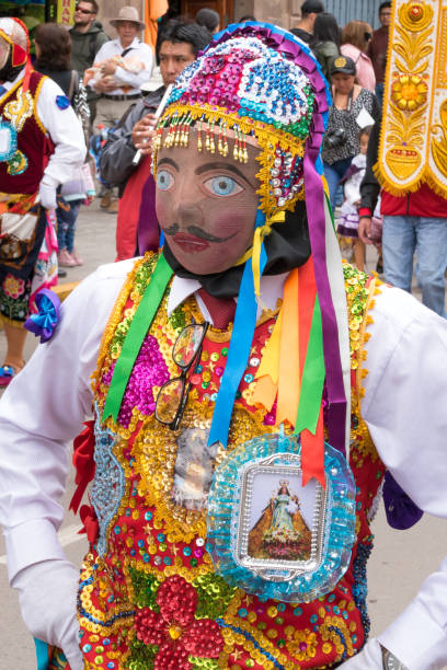 Parade in the historic center of Cusco, Peru. Cusco, Peru - october 08, 2018: People take part in the religious parade of the Virgin of the Rosary and walk in the historic center of Cusco in traditional masks and dresses, in Cusco, Peru. ethnic cleansing stock pictures, royalty-free photos & images