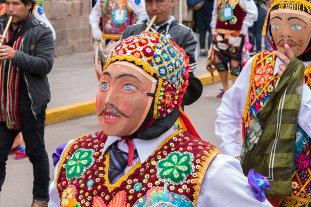 Parade in the historic center of Cusco, Peru. Cusco, Peru - october 08, 2018: People take part in the religious parade of the Virgin of the Rosary and walk in the historic center of Cusco in traditional masks and dresses, in Cusco, Peru. ethnic cleansing stock pictures, royalty-free photos & images