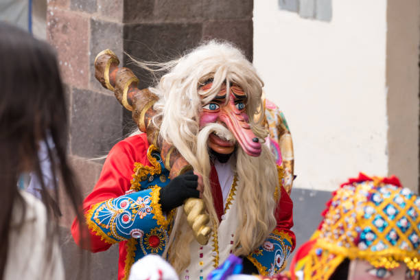 Parade in the historic center of Cusco, Peru. Cusco, Peru - october 08, 2018: People take part in the religious parade of the Virgin of the Rosary and walk in the historic center of Cusco in traditional masks and dresses, in Cusco, Peru. ethnic cleansing stock pictures, royalty-free photos & images