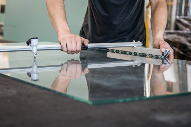 istock The glazier cuts the float glass a professional table with the use of specialized equipment 1269700929