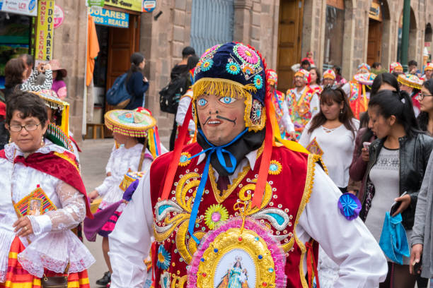 Parade in the historic center of Cusco, Peru. Cusco, Peru - october 08, 2018: People take part in the religious parade of the Virgin of the Rosary and walk in the historic center of Cusco in traditional masks and dresses, in Cusco, Peru. ethnic cleansing stock pictures, royalty-free photos & images