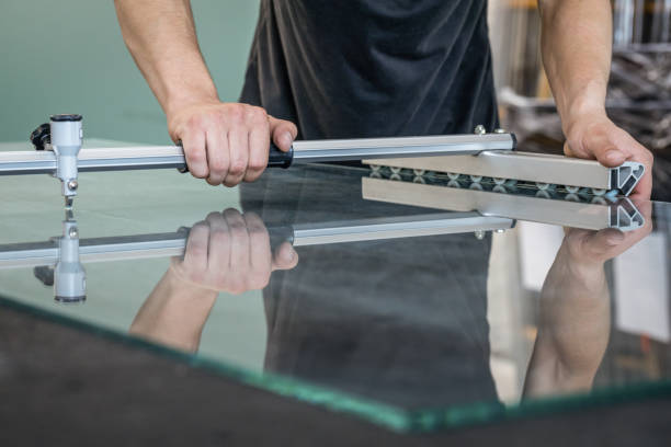 istock The glazier cuts the float glass a professional table with the use of specialized equipment 1269700943