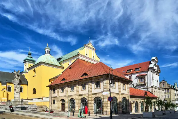 Historic tenement houses, a monument to a lancer and a baroque church in the center of Poznan