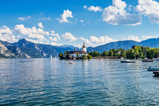 Lake Traunsee in Salzkammergut, Austria and in the middle of the lake Castle Ort or Orth, an Austrian castle in Gmunden foudend around 1080