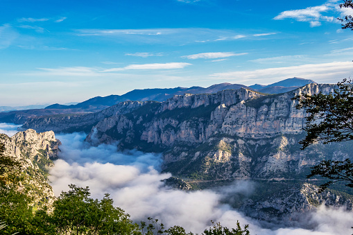 Morning mist hanging over Verdon Gorge, Gorges du Verdon, amazing landscape of the famous canyon with winding turquoise-green colour river and high limestone rocks in French Alps, Provence, France