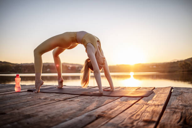 istock Young woman stretching body in nature 1269708588