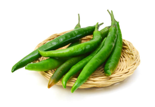 istock Green peppers isolated in basket on white 1269709197