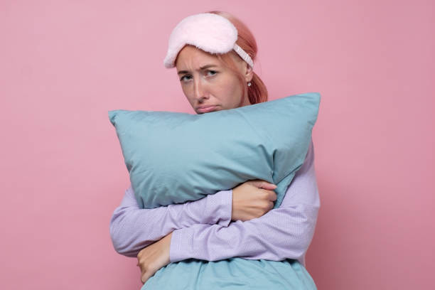 istock Sad caucasian woman holds pillow, suffers from insomnia, has problems with sleeping 1269711118