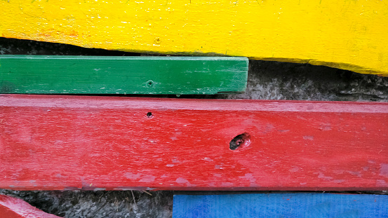 Restored old wooden boards painted multicolored. Close-up. Horizontal image with Copy Space, wood planks,  red, yellow,blue,green boards .Galicia, Spain.