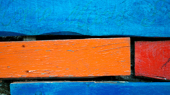 Restored old wooden boards painted multicolored. Close-up. Horizontal image with Copy Space, wood planks,  red, yellow,blue,green boards .Galicia, Spain.
